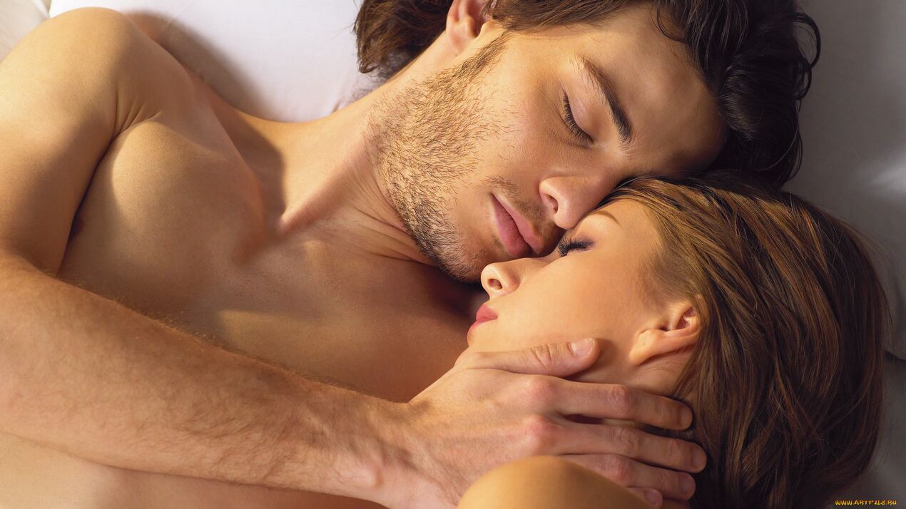 a woman in bed with a man using potency products